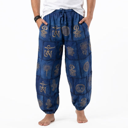 Close-up detail of the blue stonewashed organic cotton harem pants for men, highlighting the tribal pattern and soft fabric texture.