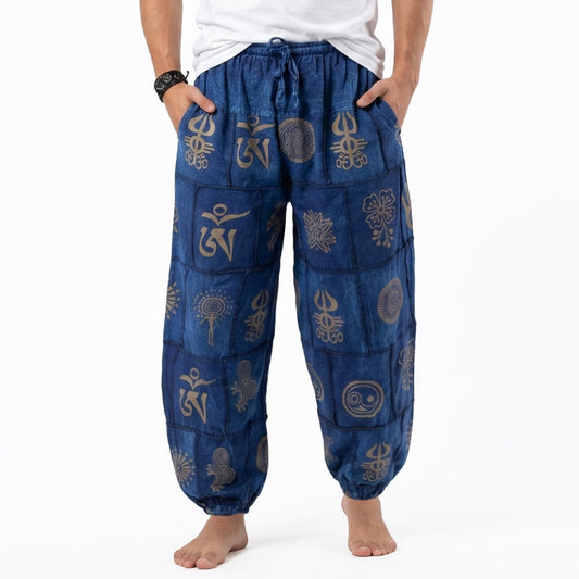 Close-up detail of the blue stonewashed organic cotton harem pants for men, highlighting the tribal pattern and soft fabric texture.