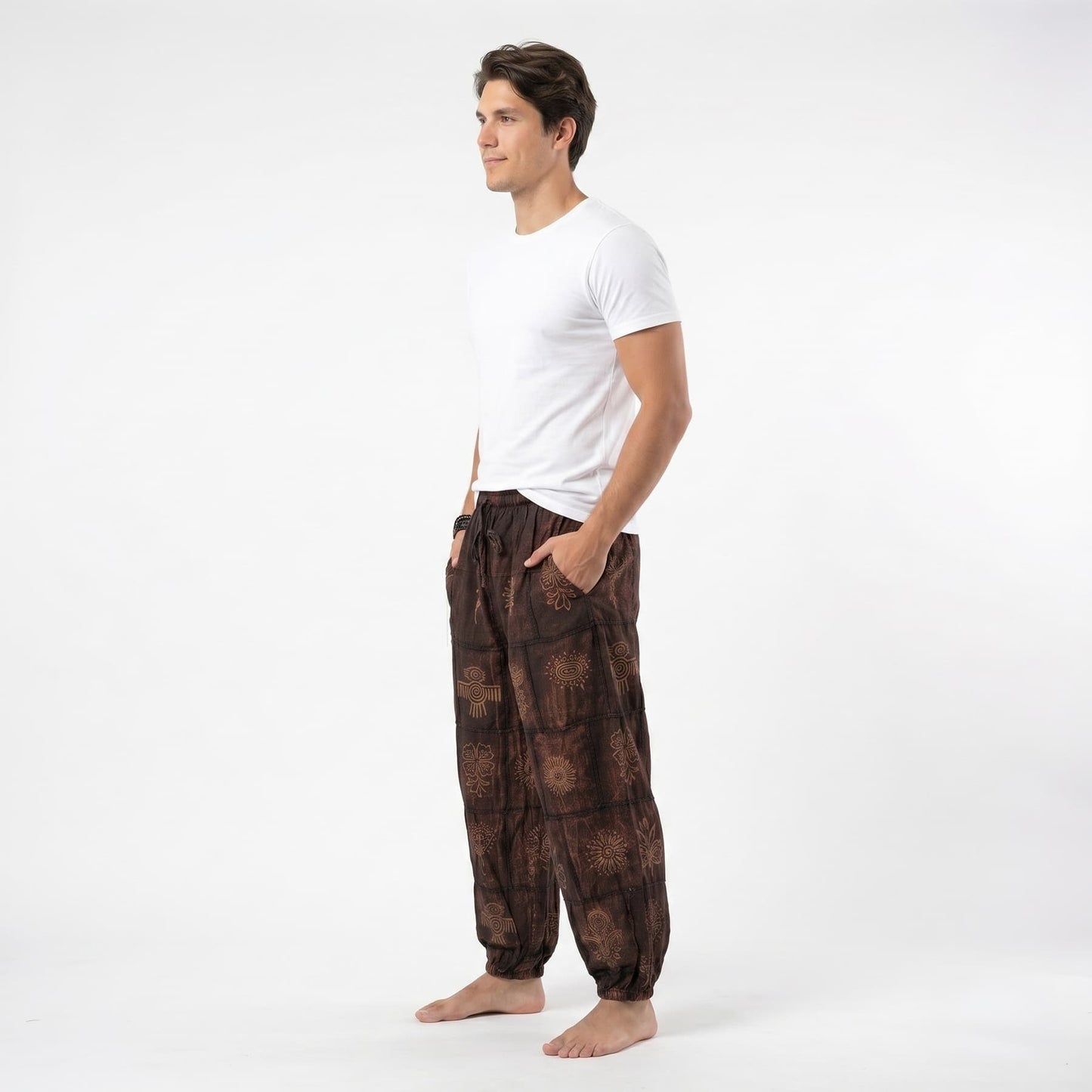 Side profile of the brown organic cotton tribal harem pants for men, showing the relaxed wide-leg silhouette.