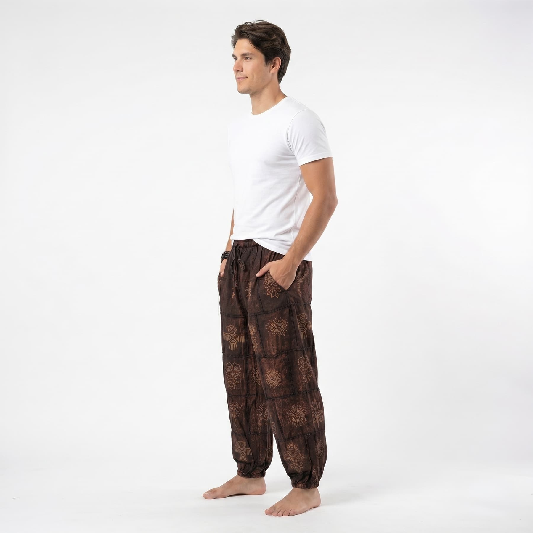 Side profile of the brown organic cotton tribal harem pants for men, showing the relaxed wide-leg silhouette.