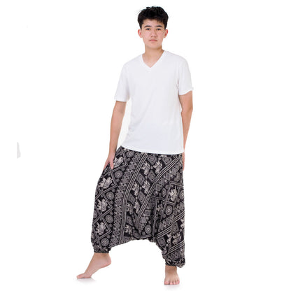 Man in black boho drop crotch pants, handcrafted in Thailand for style and comfort.