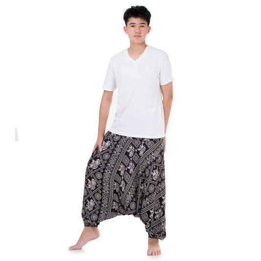Man in black boho drop crotch pants, handcrafted in Thailand for style and comfort.