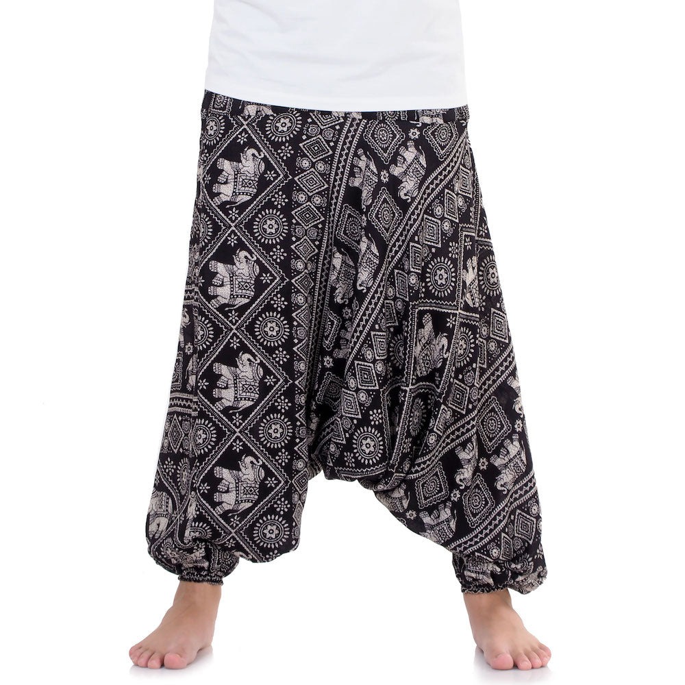 Close-up black drop crotch harem pants with traditional elephant print.