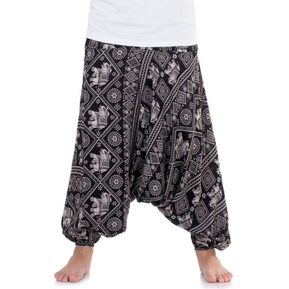 Close-up black drop crotch harem pants with traditional elephant print.