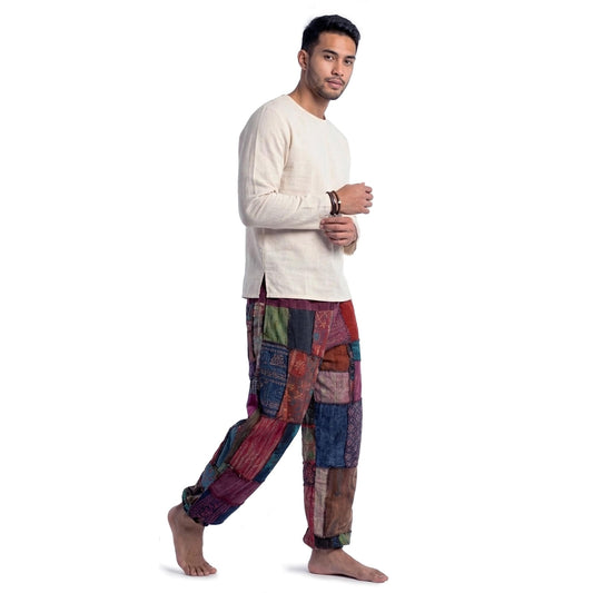 Male model wearing a purple men Thai patchwork harem yoga pants with white shirt, front view