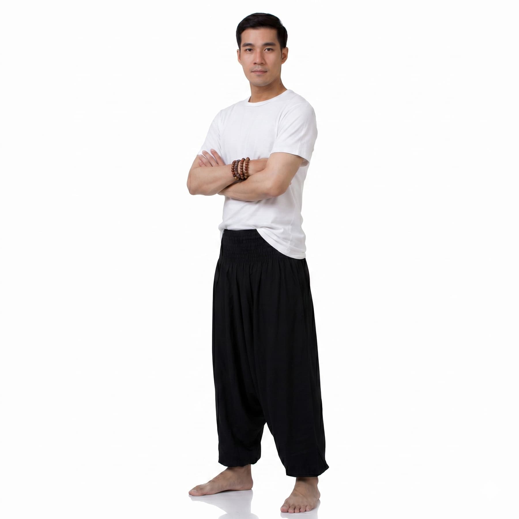Side view of the black low crotch pants for men, displaying the loose baggy silhouette.