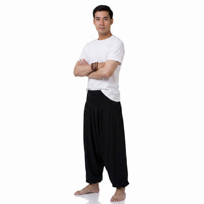 Side view of the black low crotch pants for men, displaying the loose baggy silhouette.