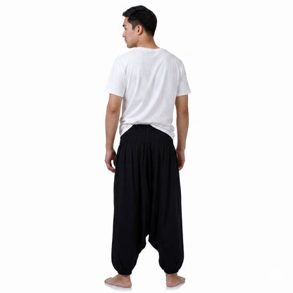 Rear view of the black Men's drop crotch harem pants, showcasing sustainable and relaxed festival fashion.