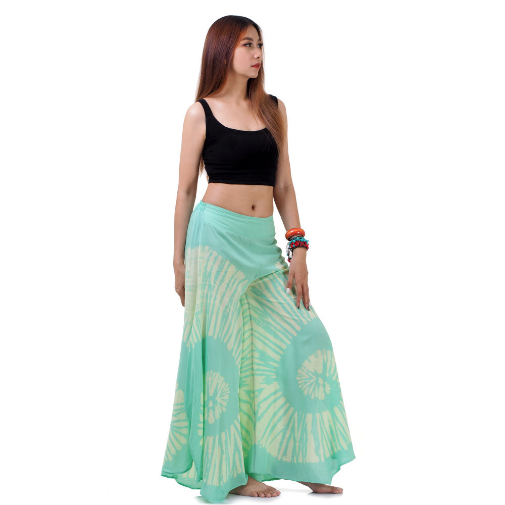 Side view of the Fresh Mint Hippie Tie Dye Palazzo Pants on a female model, highlighting the wide flowing silhouette and movement.