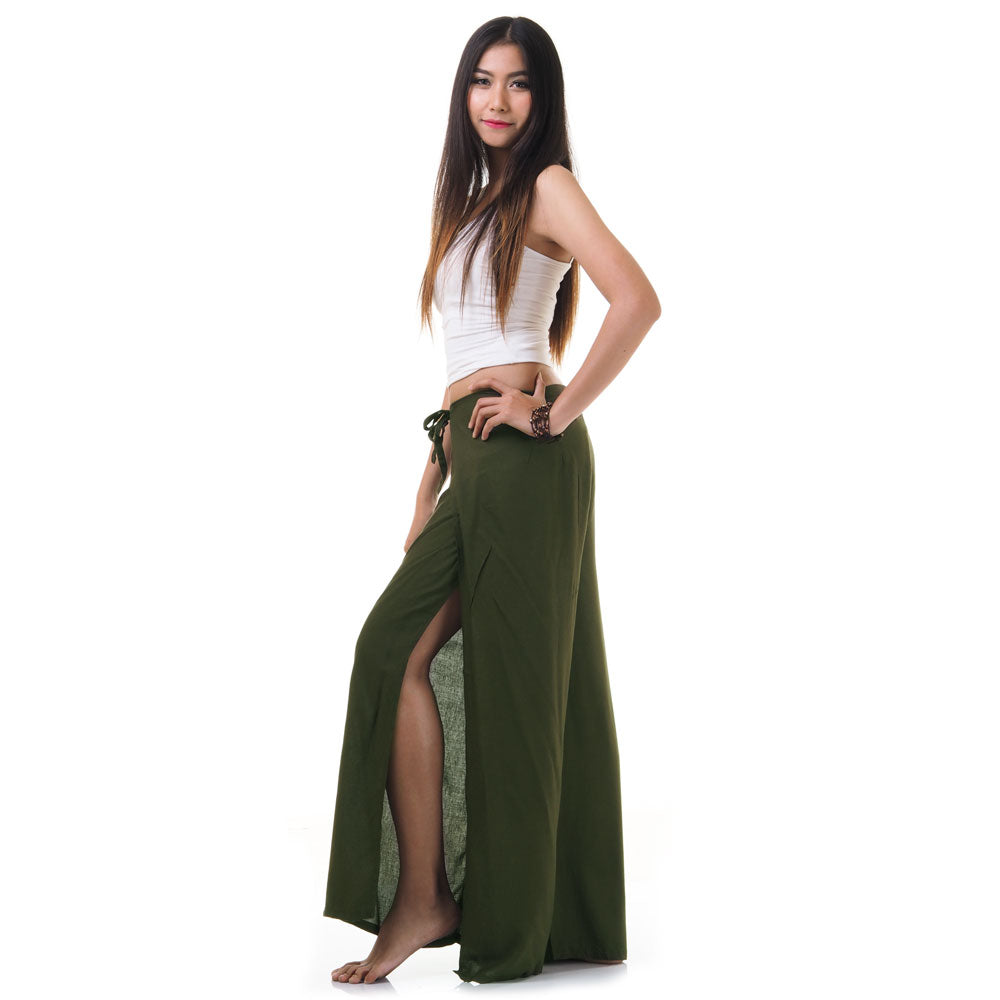 Side view of model in green Thai wrap pants skirt with white top