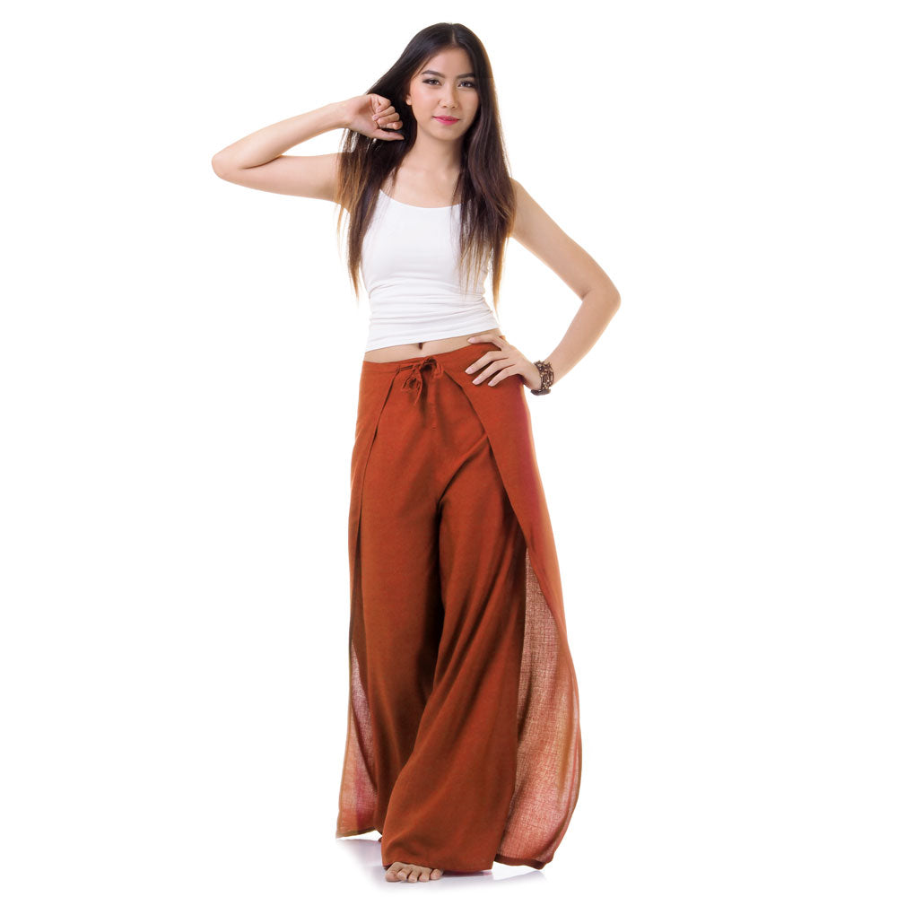 Model wearing orange Thai wrap pants skirt with white top, front view