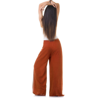 Back view of orange Thai wrap pants skirt worn with white top