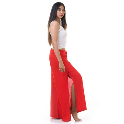 Side view of model in red Thai wrap pants skirt with white top