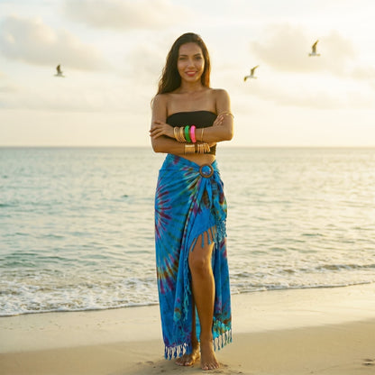 Model walking on a Thai beach in the Ocean Blue wrap skirt Phangan, matching the turquoise sea.