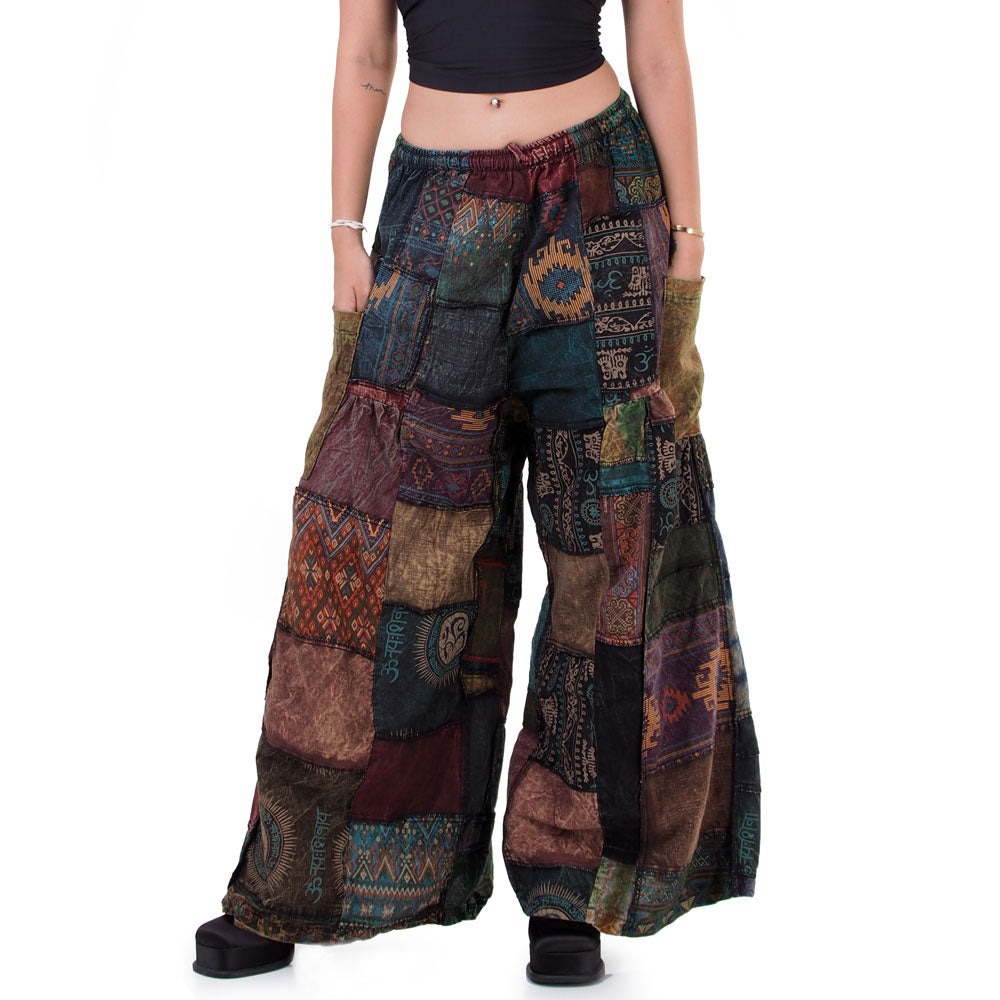 Detailed close-up of black boho patchwork wide-leg palazzo pants showing the dark ethnic patterns.