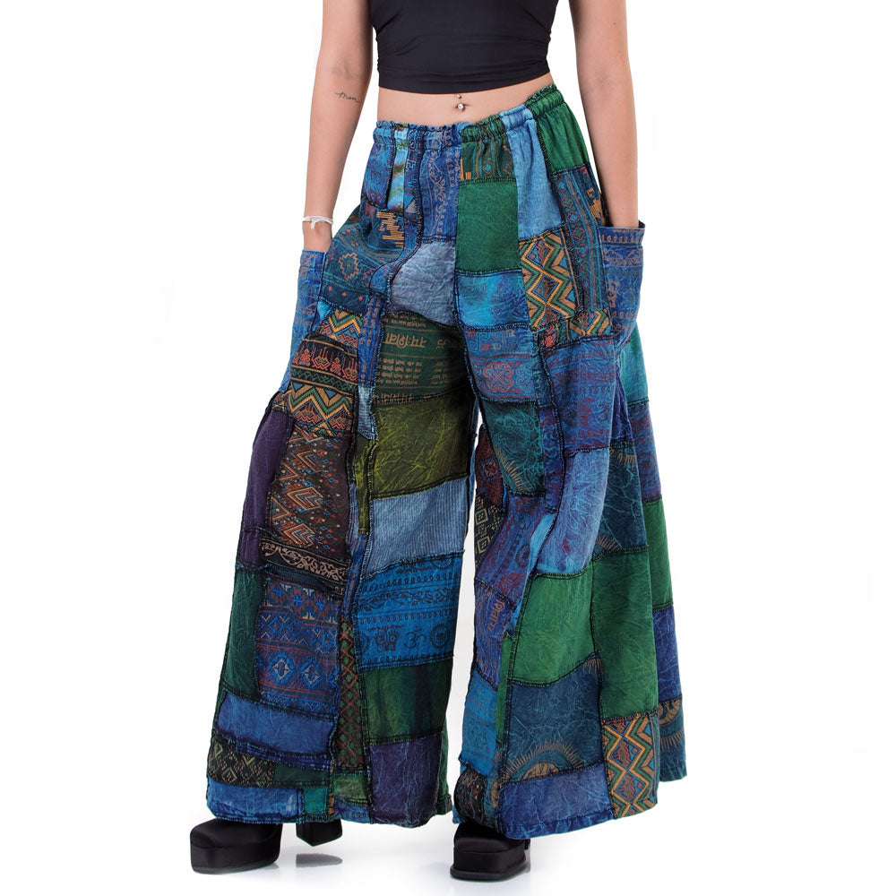 Close-up shot of blue patchwork wide-leg palazzo boho pants fabric and artisan handcraft details.