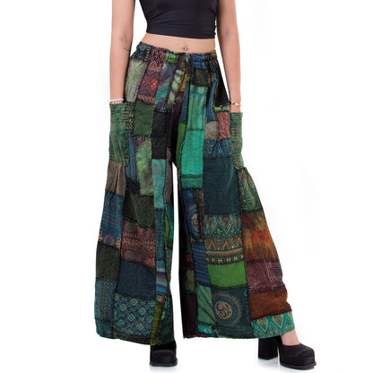 Close-up detail of green patchwork hippie palazzo boho pants made from handcrafted natural cotton.