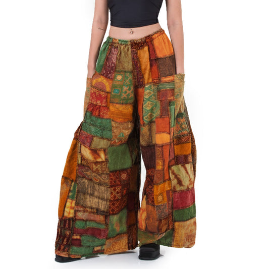 Close-up of orange patchwork wide-leg palazzo boho pants focusing on the warm orange patchwork segments.