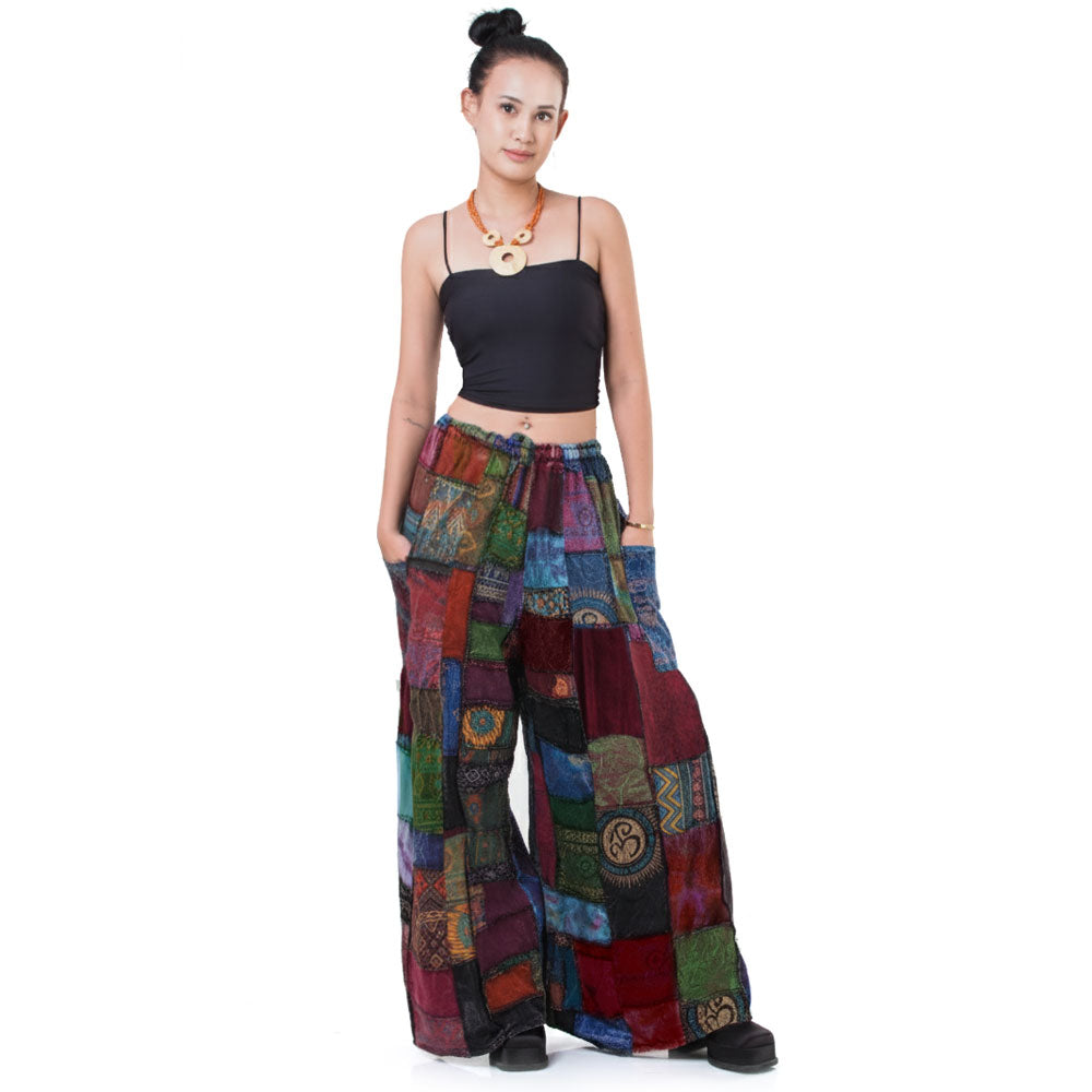 Front view: Model wearing loose-fitting, multicolored Hippie Palazzo Pants (Thai Harem style) with a white top.