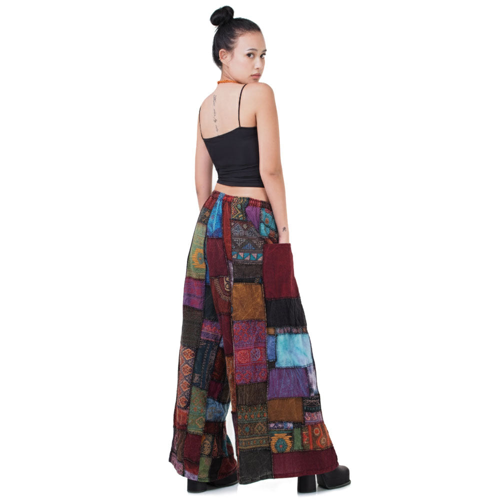 Back view of the vibrant patchwork Hippie Palazzo Pants (Thai Harem Yoga) worn with a simple black top.