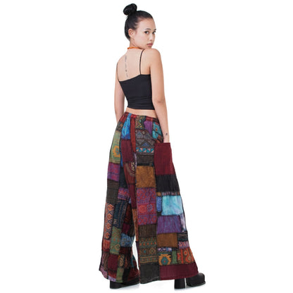 Back view of the vibrant patchwork Hippie Palazzo Pants (Thai Harem Yoga) worn with a simple black top.