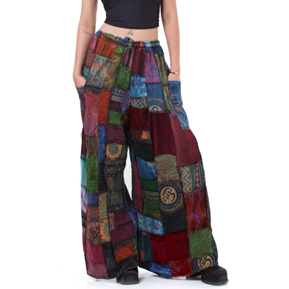 Colorful patchwork hippie palazzo pants worn by a person on a white background