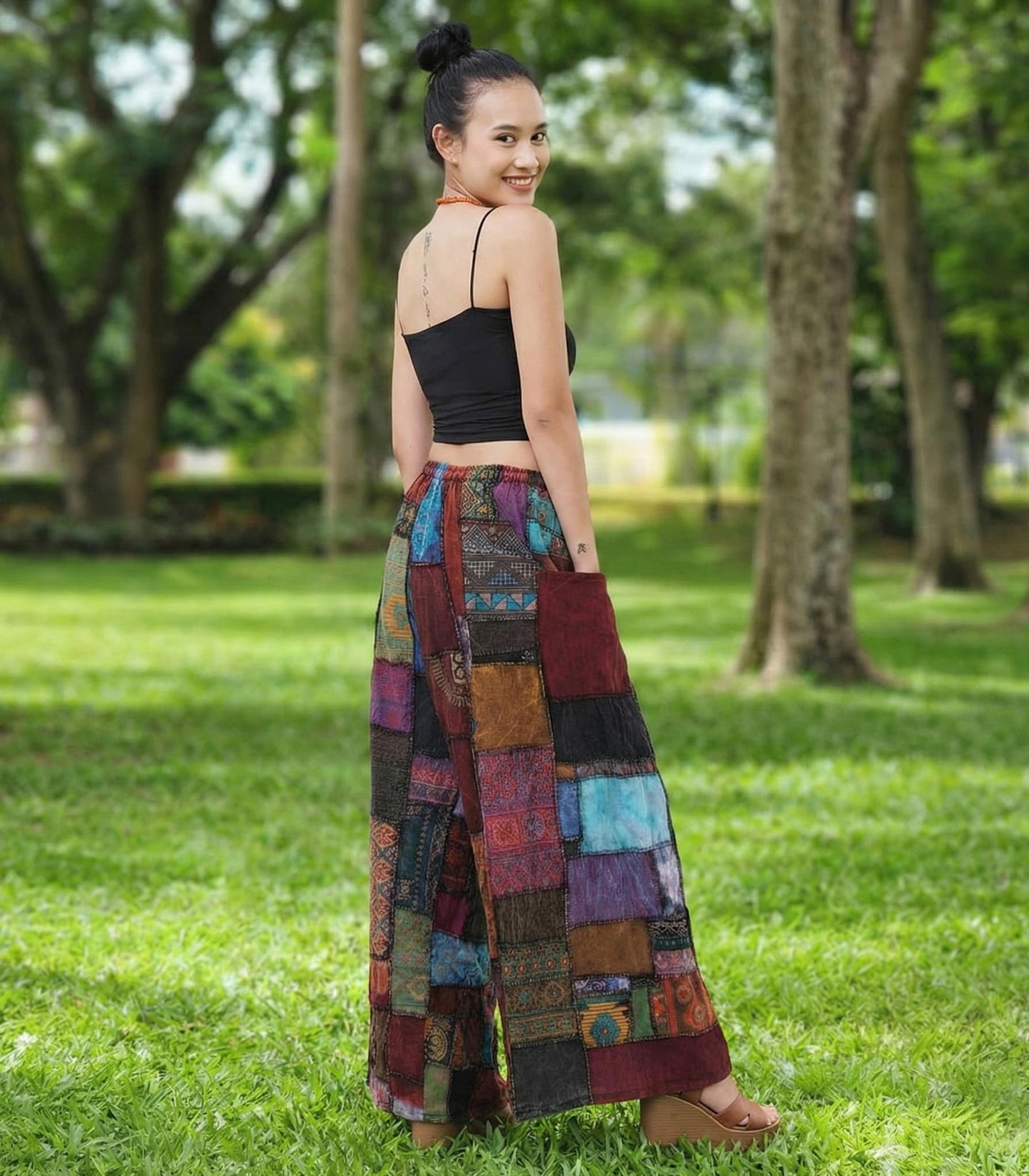Woman wearing a patchwork hippie palazzo pants in a park