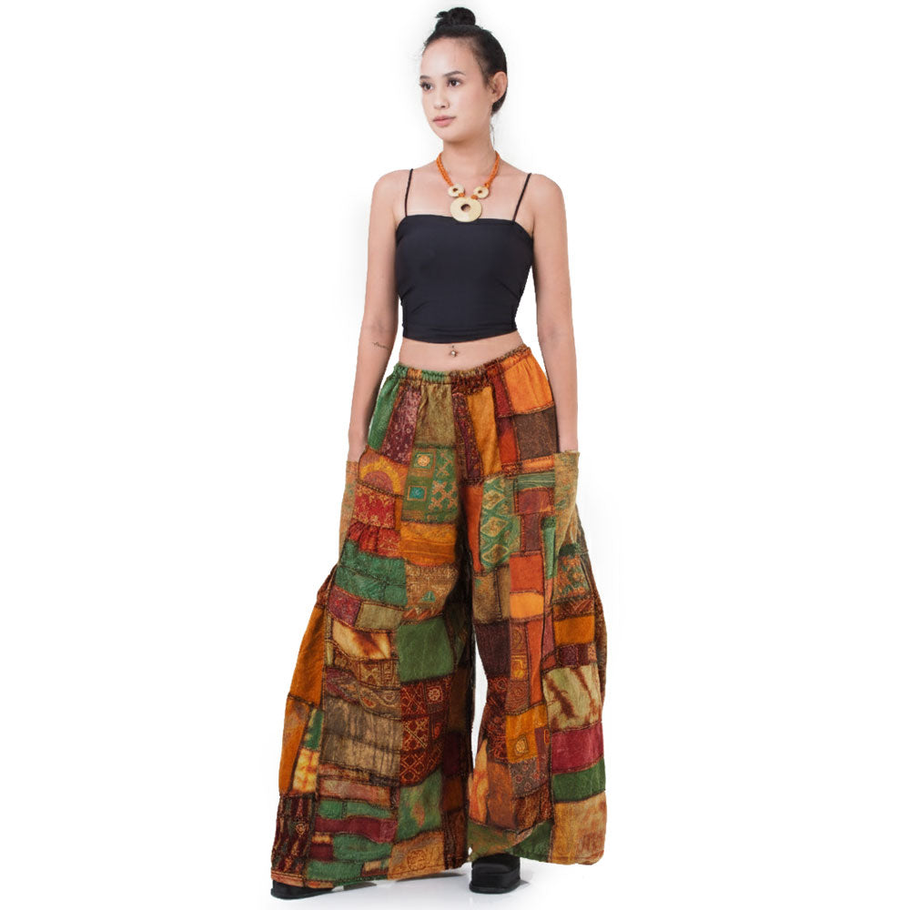Front view: Model wearing loose-fitting, multicolored patchwork Hippie Palazzo Pants (Thai Harem style) with a black top.