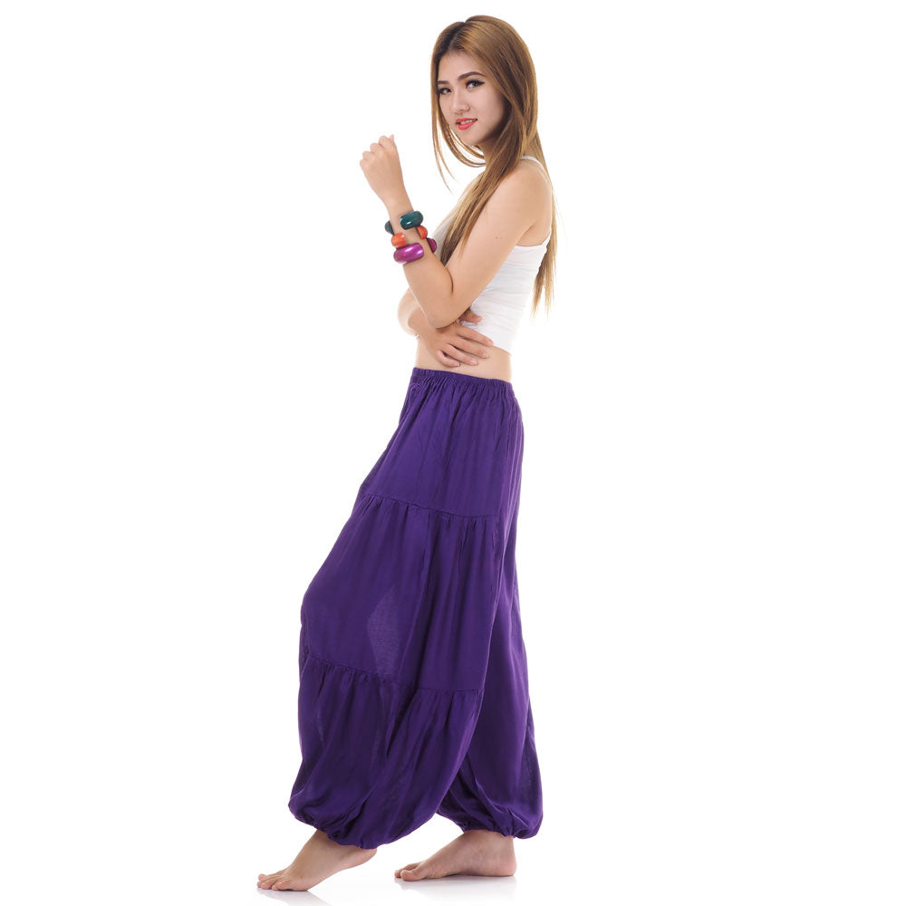 Side view of female model in purple women Thai harem yoga pants with white top