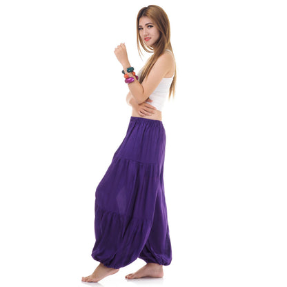 Side view of female model in purple women Thai harem yoga pants with white top