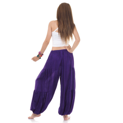 Back view of purple women Thai yoga harem pants worn with white top
