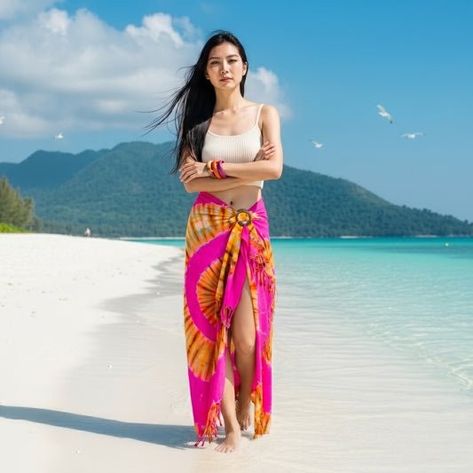 Model walking on a tropical beach in the colorful Rose Tie Dye wrap skirt Phangan.