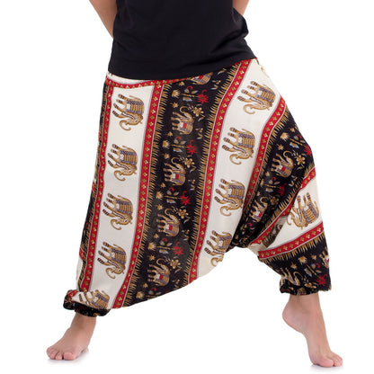 Close-up black drop crotch harem pants with majestic Royal Thai Elephant print.