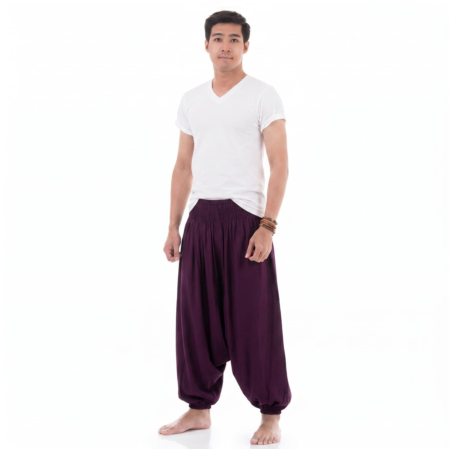 Side profile of the purple low crotch harem pants for men, showcasing the flexible elastic ankle cuffs.