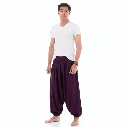 Side profile of the purple low crotch harem pants for men, showcasing the flexible elastic ankle cuffs.
