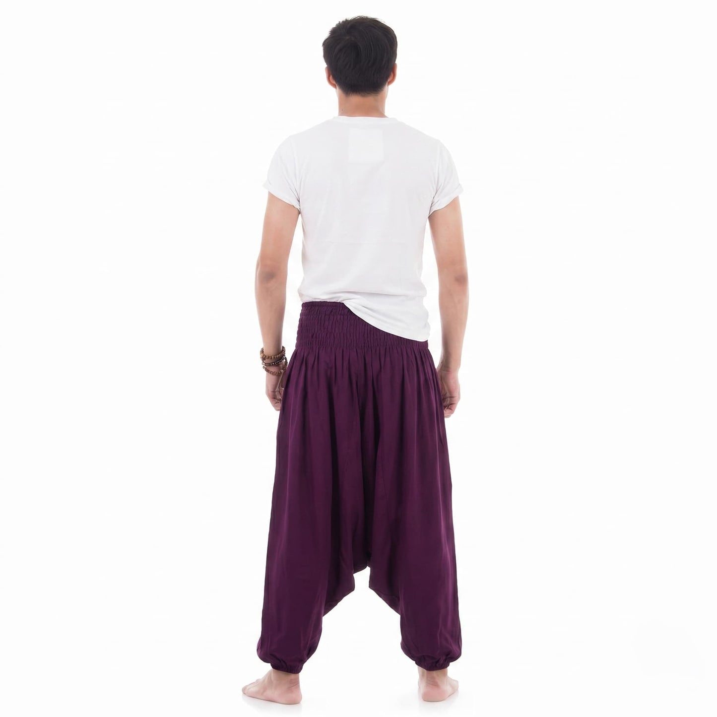 Rear view of the purple Men's drop crotch harem pants, emphasizing the loose-fitting bohemian holiday style.