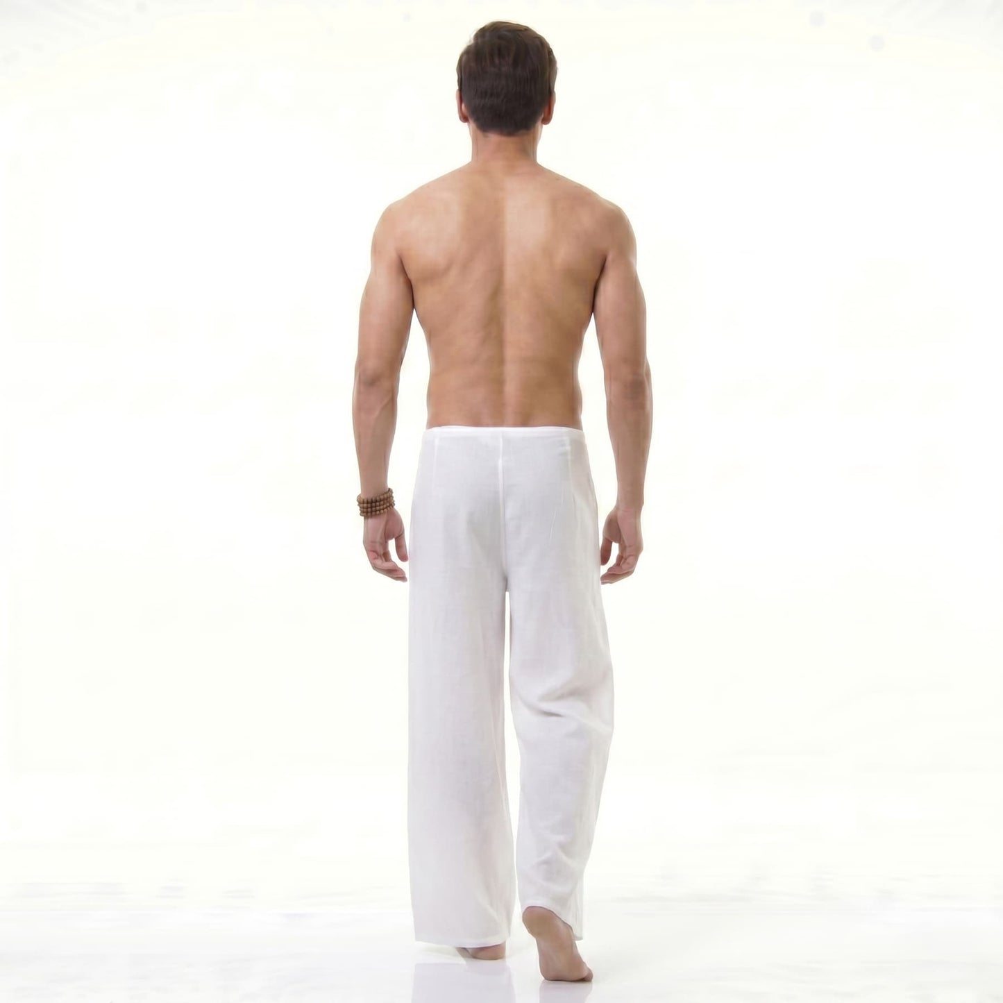 Rear view of the white Men's Thai wrap pants, offering a lightweight fit for hot days.