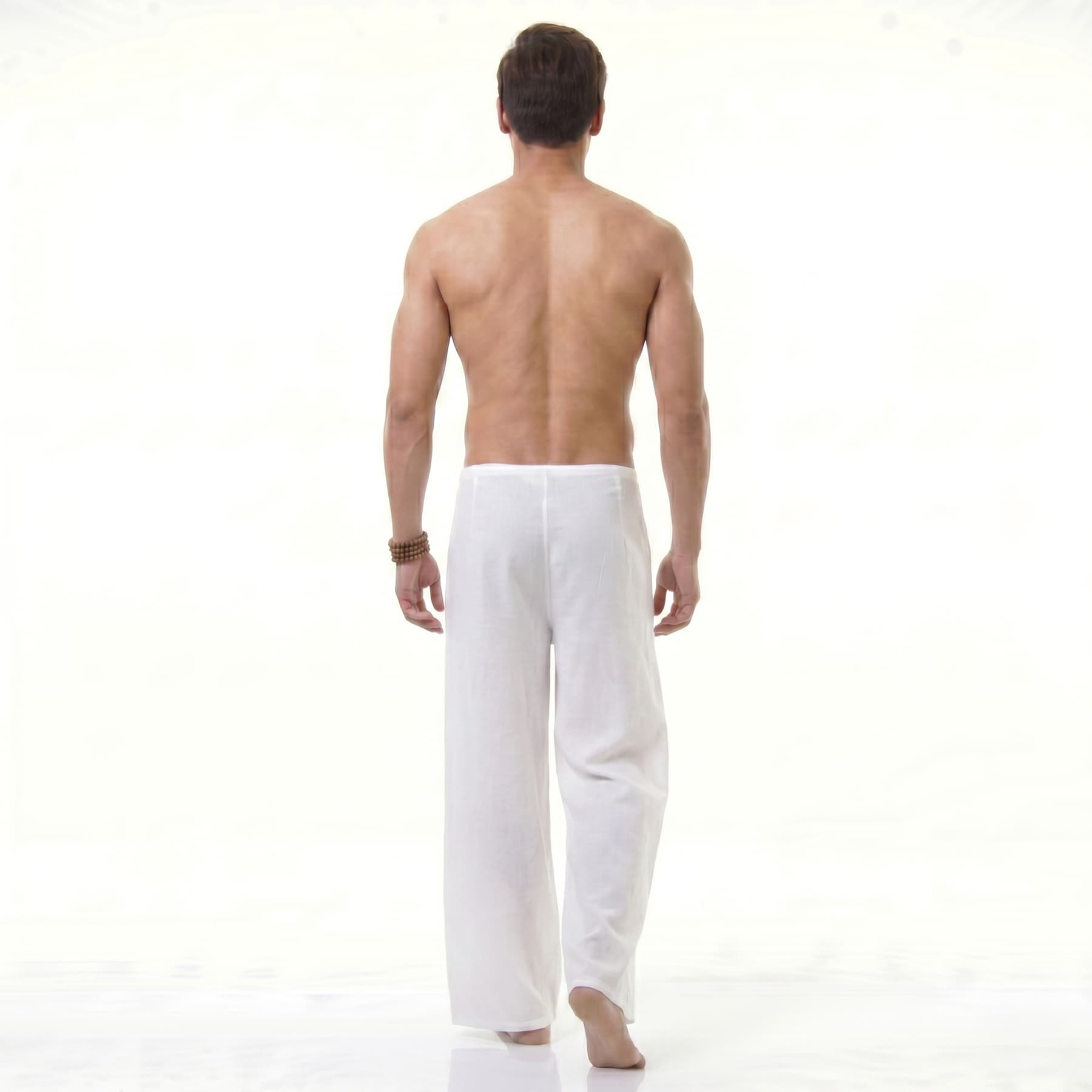Rear view of the white Men's Thai wrap pants, offering a lightweight fit for hot days.