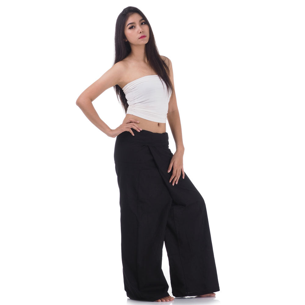 Side profile of a female model showing the relaxed fit and adjustable waistband of Midnight Black Thai fisherman pants.