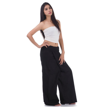 Side profile of a female model showing the relaxed fit and adjustable waistband of Midnight Black Thai fisherman pants.
