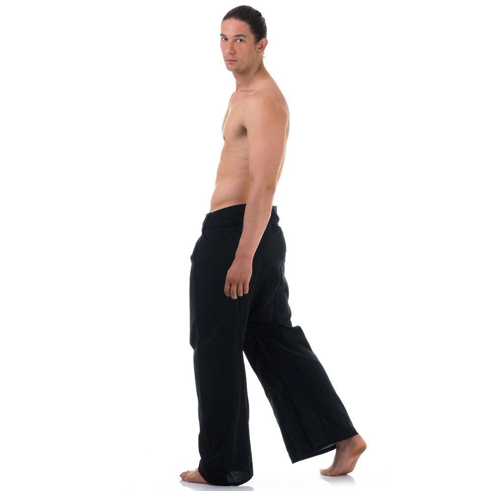 Back view of male model wearing Midnight Black men's Thai fisherman pants, showcasing the tied waist and flowing fabric.