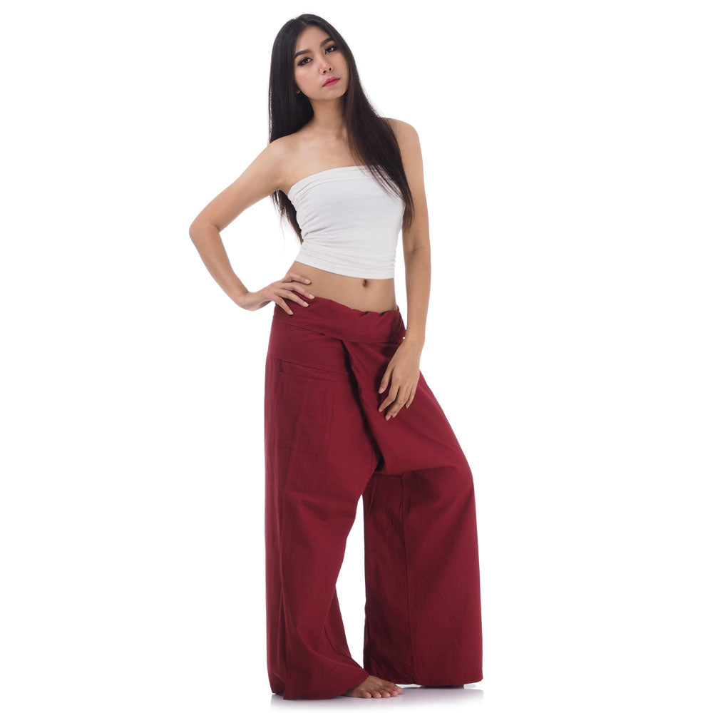 Side profile of a female model showing the relaxed fit and adjustable waistband of Mystic Maroon Thai fisherman pants.