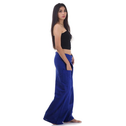 Side profile of a female model showing the relaxed fit and adjustable waistband of Oceanic Navy Thai fisherman pants.