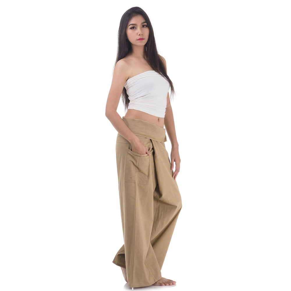 Side profile of a female model showing the relaxed fit and adjustable waistband of Sandy Beige Thai fisherman pants.