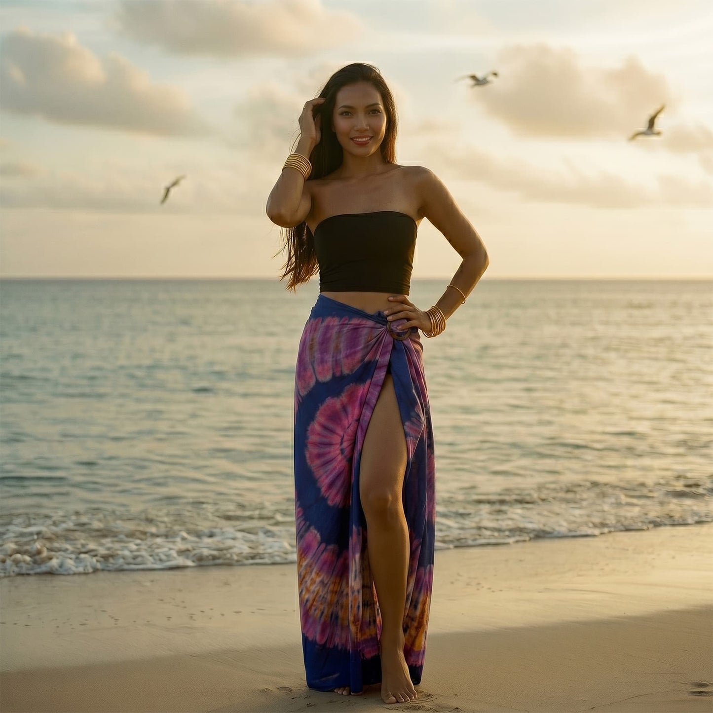 Female model in a tropical setting wearing the Purple Tie Dye wrap skirt Samui by the ocean.