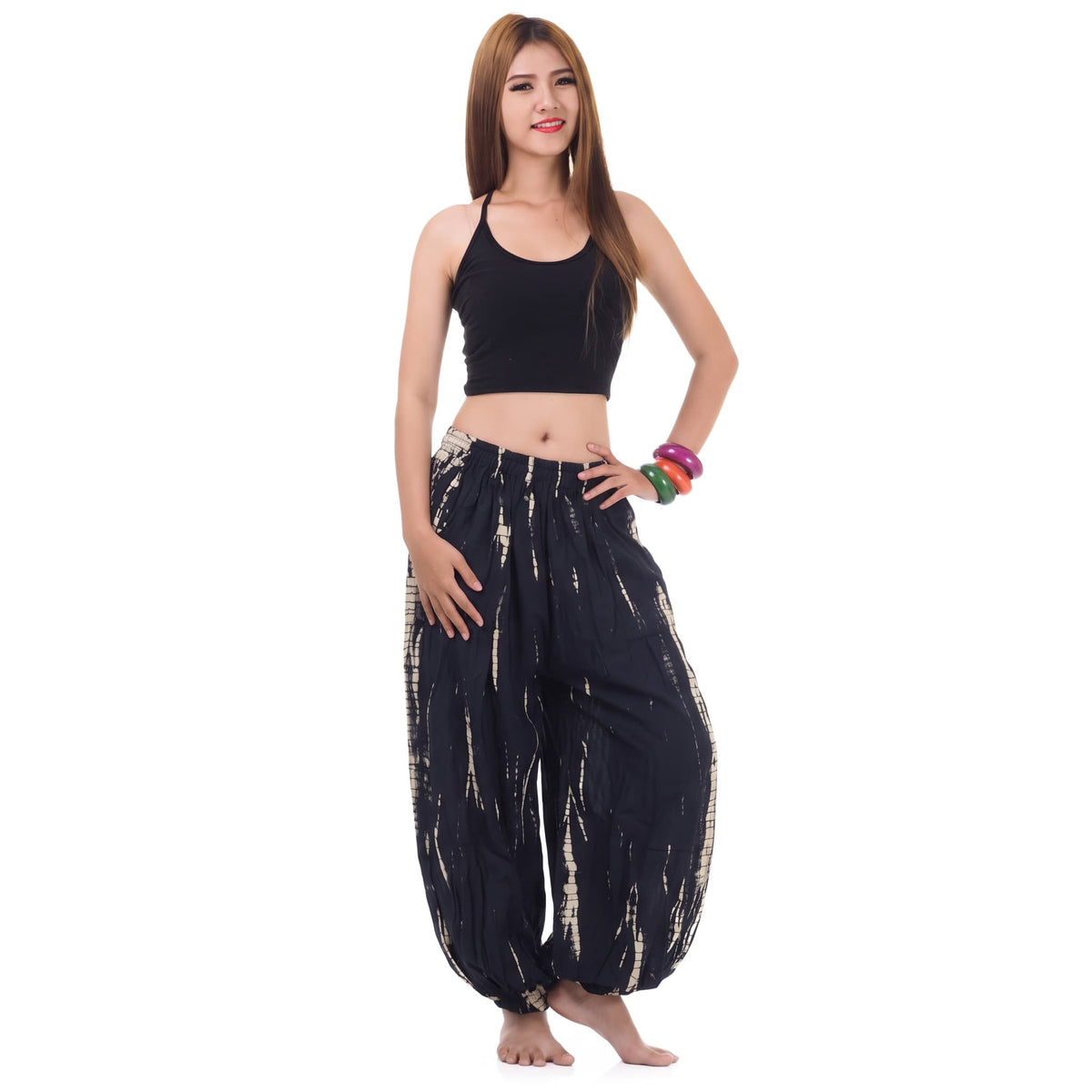 Front view of the Midnight Black Women's Tie Dye Harem Pants on a female model, featuring a comfortable elastic waistband.