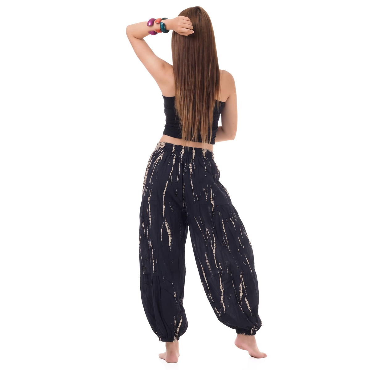 Rear view of the Midnight Black Women's Tie Dye Harem Pants on a female model, displaying the airy and relaxed bohemian fit.