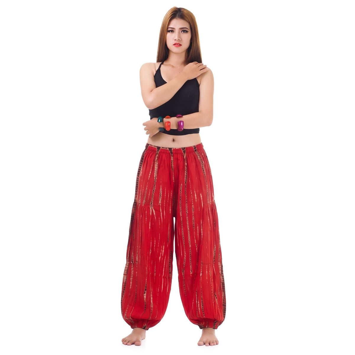 Front view of the Women's Tie Dye Harem Pants Vibrant Red on a female model, designed with a comfortable gathered waistband.