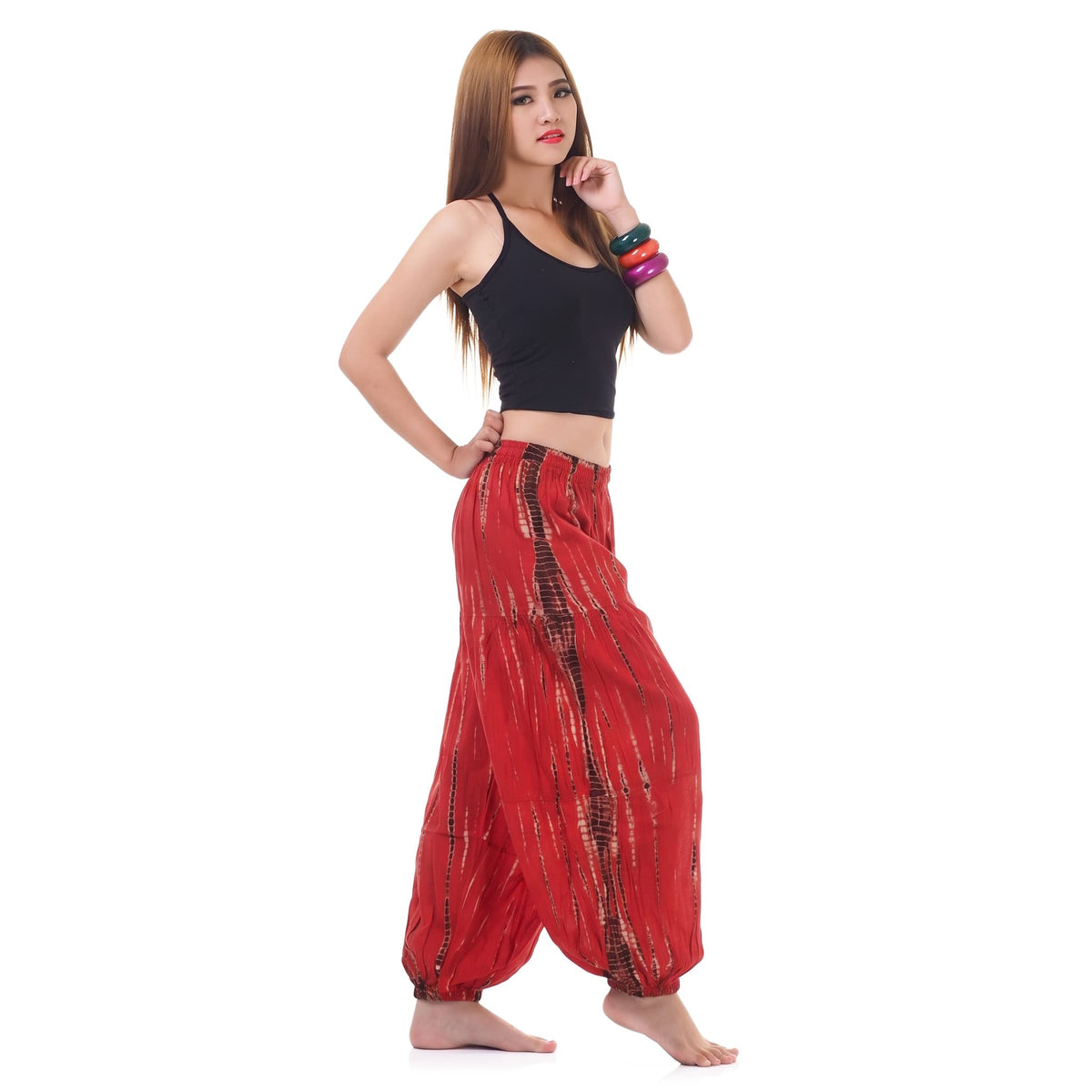 Side view of the Women's Tie Dye Harem Pants Vibrant Red, demonstrating the loose and airy harem silhouette.
