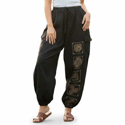 Close-up of black stonewashed tribal mandala harem pants highlighting the contrasting mandala prints and seams.